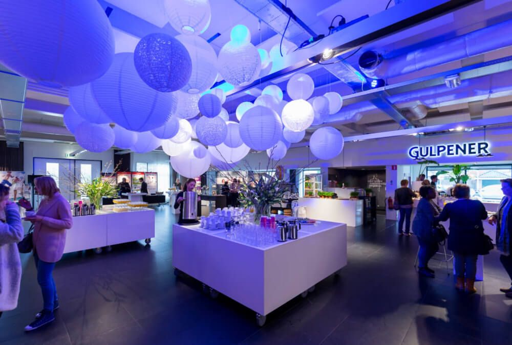 Foodcourt, in blauw licht met witte balonnen in het midden